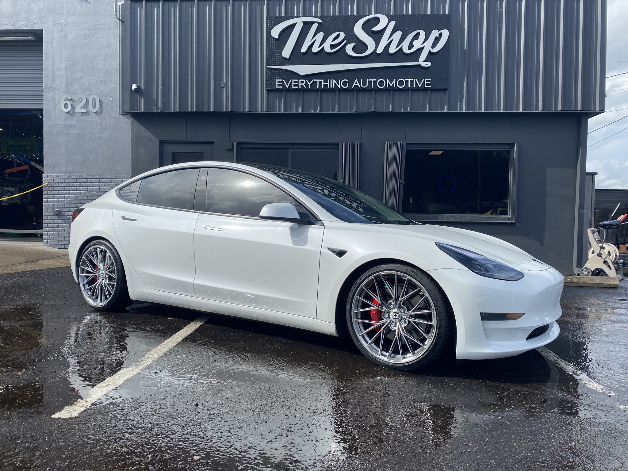 Custom wheels and tires with lowering springs on a Tesla Model 3