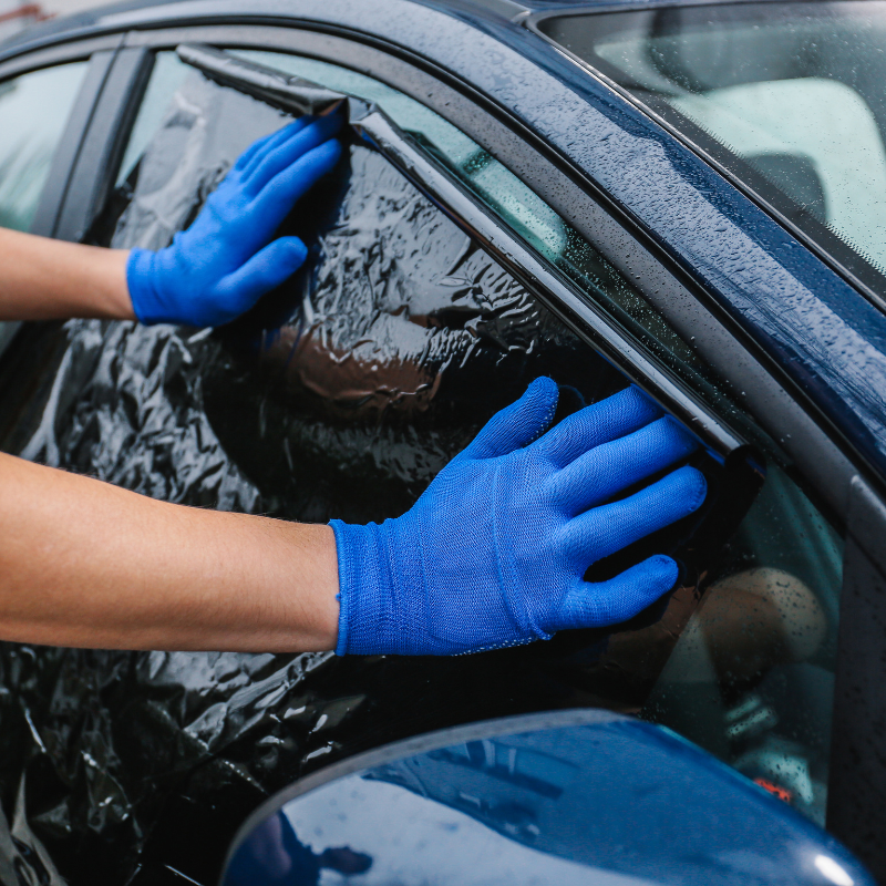 Ceramic window tint being installed on a car.
